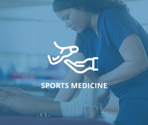 service-sport-medicine.jpg A sports medicine professional wrapping an athlete's ankle with a focus on treatment and recovery.